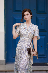 a lady in a blue floral printed dress